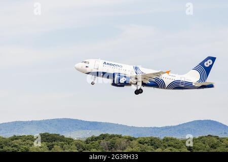 Russia, Vladivostok, 08/17/2020. Passenger jet aircraft Airbus A319 of Aurora Airlines in a sky. Journey and holidays. Aviation Stock Photo