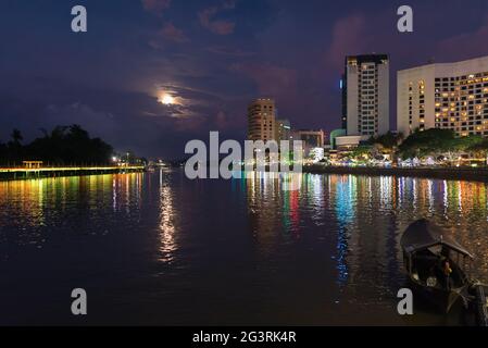 The Sarawak river in Kuching on Borneo at night Stock Photo