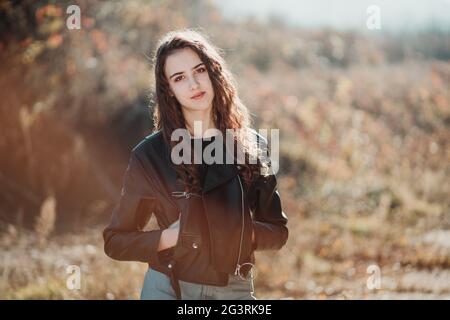 Portrait of strong woman in leather jacket, leggings, sunglasses and silk  bandana Stock Photo - Alamy