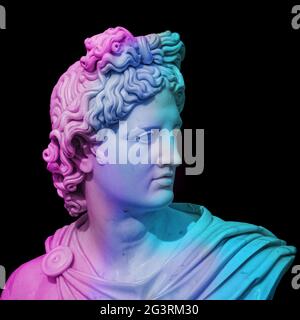 Statue of of Apollo God of Sun. Creative concept colorful neon image with ancient greek sculpture Apollo Belvedere head. Webpunk Stock Photo