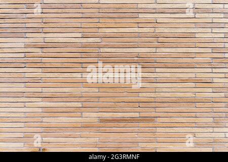 New, rustic brown and beige brick or tile wall. Stock Photo