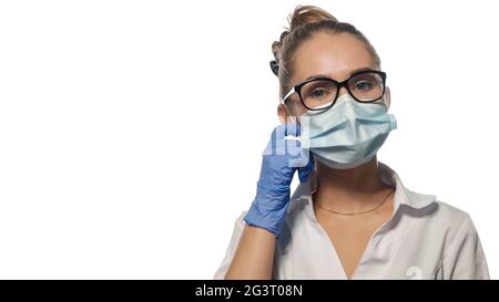 Young doctor fixing her mask. Stock Photo