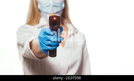 Female medical worker measures the temperature with thermometer. Close up shot. Stock Photo