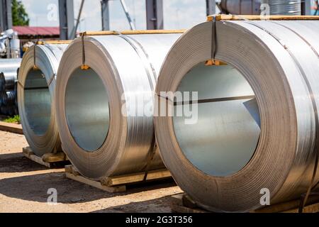 Stainless steel rolls. Rolls of steel sheet in the warehouse. A roll of galvanized steel sheet for the production of metal pipes and tubes in a Stock Photo