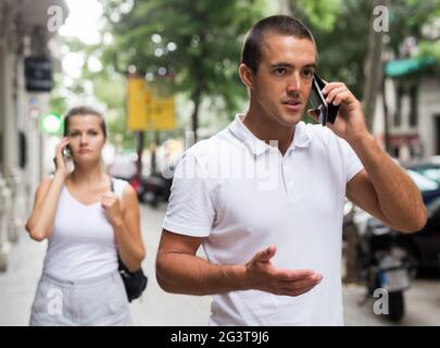 Male amd female talking on smartphones Stock Photo