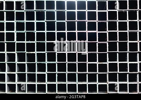 Squares holes background . Stainless steel profiles . Squares shaped pattern Stock Photo