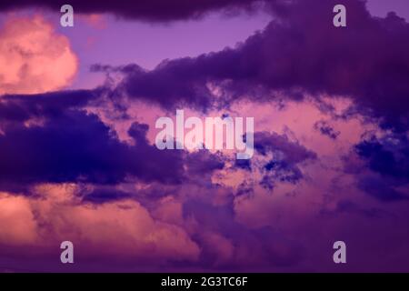 Gorgeous dramatic sunset sky with pink and purple clouds. Stock Photo