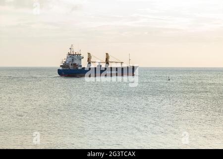 Cargo ship heading home after being offloaded Stock Photo