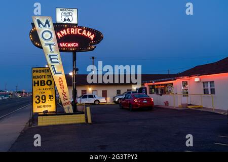 Tucamcari, New Mexico - May 6, 2021: Neon sign for the classic Motel Americana, located along Route 66, taken at dusk with sign lit up Stock Photo