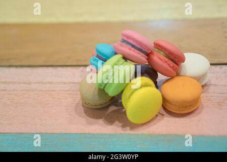 Multicolored macaroons on white wooden background Stock Photo