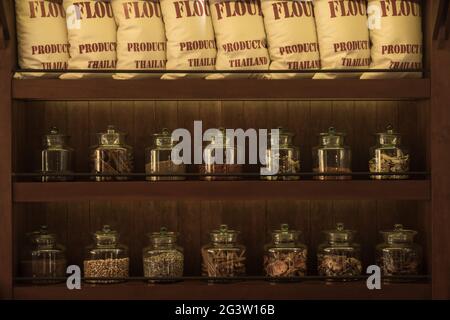 Arrangement of dry food products on dark wooden shelves Stock Photo