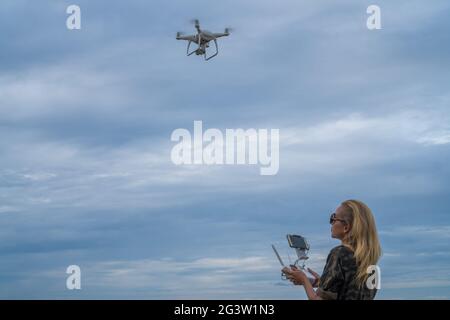 Happy woman taking photos with drone camera Stock Photo