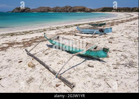 09.09.2011, Lombok, West Nusa Tenggara, Indonesia, Asia - Traditional wooden fishing boats on the shore of the pristine white sandy Tanjung Aan Beach. Stock Photo