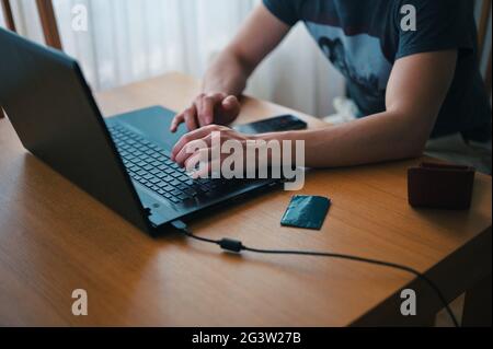Midsection of man using laptop Stock Photo