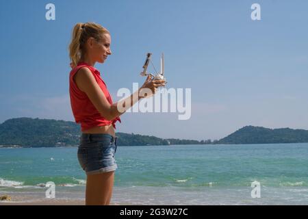 Pretty woman taking photos with drone camera Stock Photo