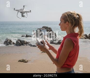 Pretty woman taking photos with drone camera Stock Photo