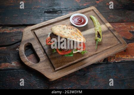 Meatball Sandwich with tomatoes, onion and green pepper on rustic wooden background Stock Photo