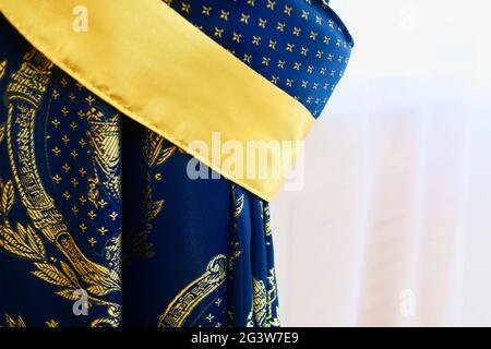 Luxurious blue curtains and white tulle close-up. classic window darkening from sunlight. Stock Photo