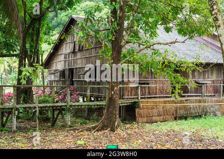 Traditional Iban longhouse in the Sarawak Cultural Village on Borneo Stock Photo