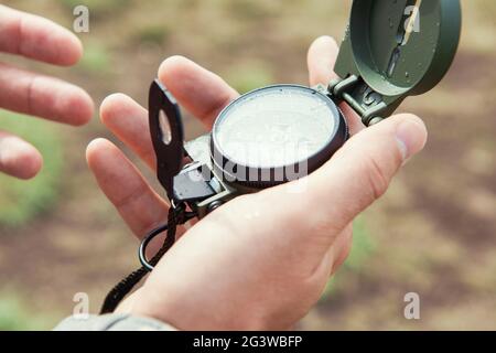 Man with compass in hand outdoor Stock Photo