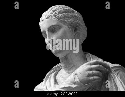 Face of statue of grieving woman isolated on black background. Plaster antique sculpture of young woman face. Gypsum head portra Stock Photo