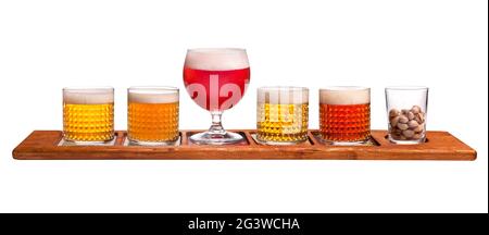 Five kinds of different kinds of beer on a wooden stand. Dark beer, light, unfiltered, red beer, dark Irish ale Stock Photo