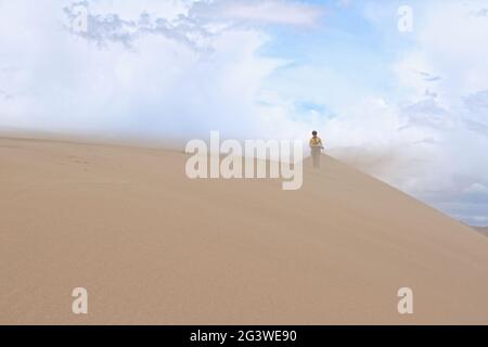 Tourist Walking Along the Edge of the Sand Dune.