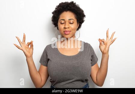 African woman meditates and relaxes. Stock Photo