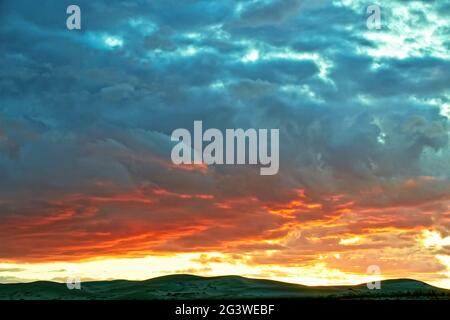 Evening cloudy sky over the sand dunes. Stock Photo