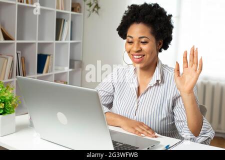 African woman communicates on a video call remotely using a laptop. Online webinar. Stock Photo