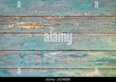 Grunge background with wooden dark teal blue colored old weathered planks with chipped paint Stock Photo