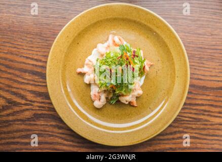 Large boiled tiger prawns with herbs and vegetables. Snack for lunch in a cafe. Stock Photo
