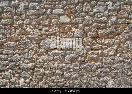 Old grungy stone or sandstone wall Stock Photo