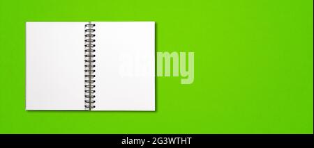 Blank open spiral notebook isolated on green banner Stock Photo