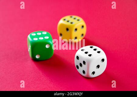 Three colorful dices isolated on pink background Stock Photo