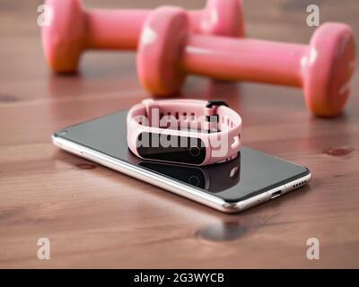 Fitness tracker on smartphone wooden tabletop Stock Photo