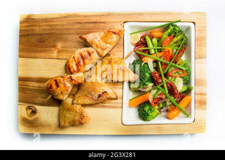 Beer snack: spicy chicken wings, cheese balls, fried black bread toast with garlic, onion rings in batter. Snack on a white back Stock Photo