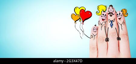 Finger puppets of loving parents with young child hugging and having fun. Stock Photo