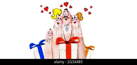 Finger puppets of loving parents with young child hugging and having fun. Stock Photo