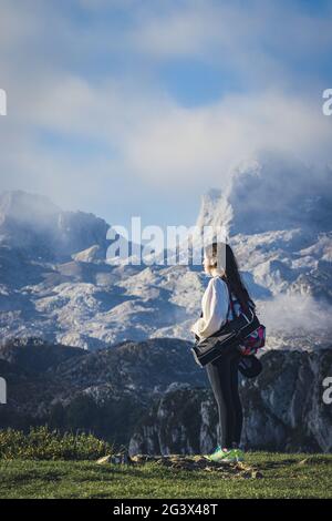 LAGOS DE COVADONGA, SPAIN - Oct 27, 2020: Girl contemplating the landscape in the lakes of covadonga (Asturias) - Spain Stock Photo