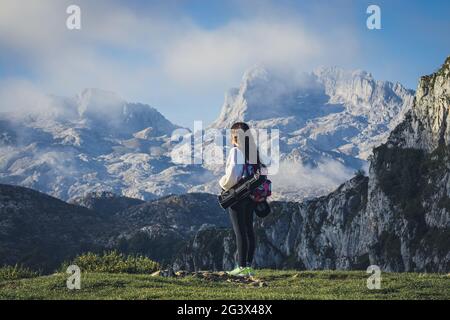 LAGOS DE COVADONGA, SPAIN - Oct 27, 2020: Girl contemplating the landscape in the lakes of covadonga (Asturias) - Spain Stock Photo