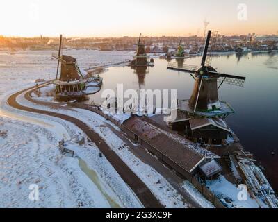 Snow covered windmill village in the Zaanse Schans Netherlands, historical wooden windmills in winter Zaanse Schans Holland Stock Photo