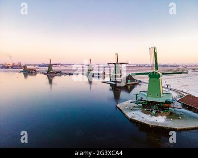 Snow covered windmill village in the Zaanse Schans Netherlands, historical wooden windmills in winter Zaanse Schans Holland Stock Photo