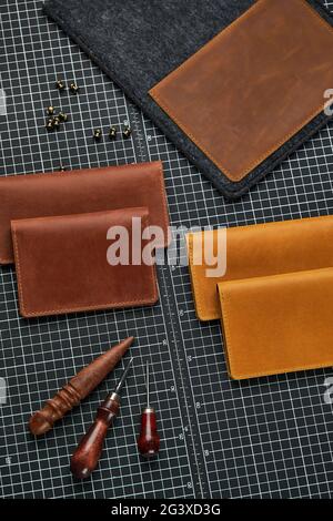 Leather goods for men. A set of men's leather accessories, a bag, a passport cover, a wallet, a handbag, a keychain case on a light background. Stock Photo
