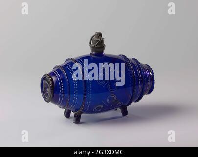Bottle in the shape of a tub. Four rectangular legs, barrel-shaped body around which as hoops twice three ribbed wires. At the widest point a short neck, caught in a tin frame with thread. Pewter screw cap with ring. On the middle coaster four white ornamental motifs, on either side and between the hoops double piped white piping. On the hoops remain from gilding. Stock Photo