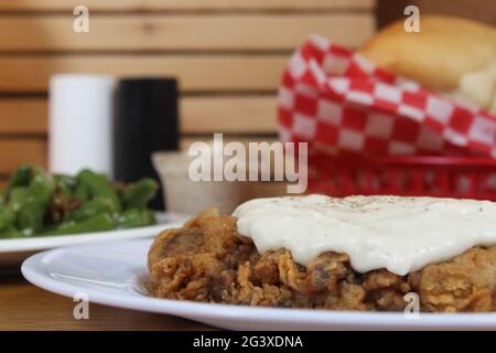 Chicken Fried Steak and Gravy With Mashed Potatoes in Rural Cafe Stock Photo