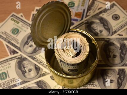 Dollars in tin can. Keeping Stack of money rolls 100 american hundred in metal food can. Large bundle of US one hundred dollar bills. Problem of corru Stock Photo