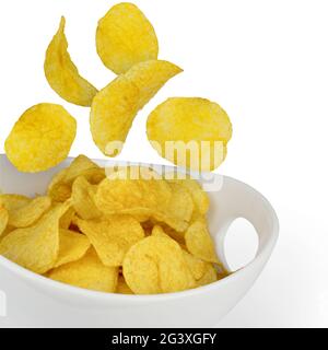 Potato chips fall into bowl Stock Photo