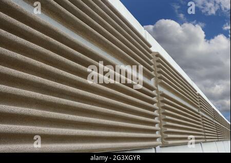A modern soundproof wall with cloudy sky in the background Stock Photo