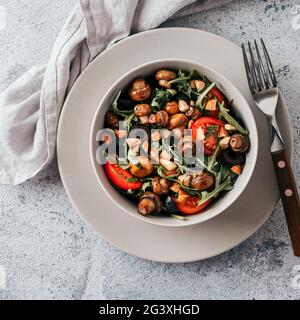 Salad with arugula, mini champignons Stock Photo